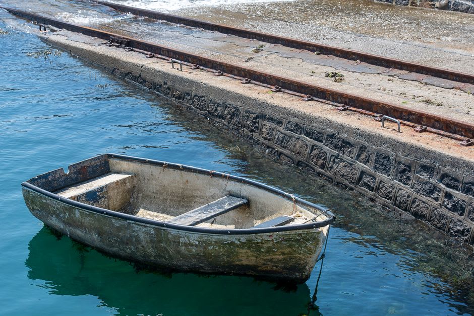 Weathered stone buildings along the quay in Paimpol's old harbor basin where Icelandic cod boats once moored