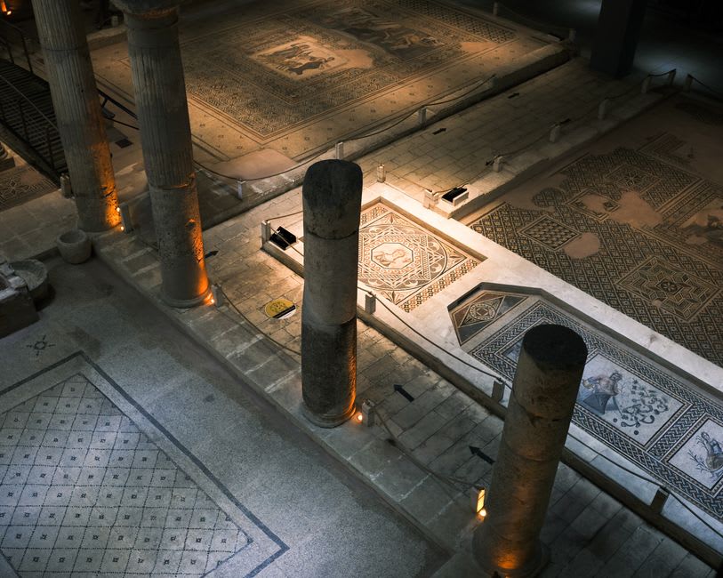 The excavated Roman villa remains and mosaic floors preserved inside the glass-walled Vesunna museum in Périgueux