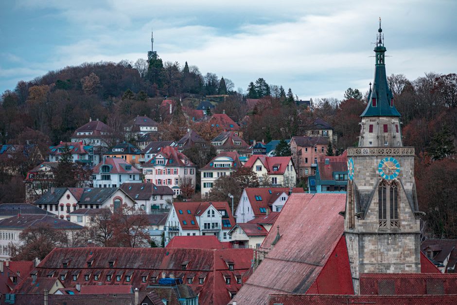 The Gothic collegiate church tower of Poligny rising above the tiled rooftops of the old town