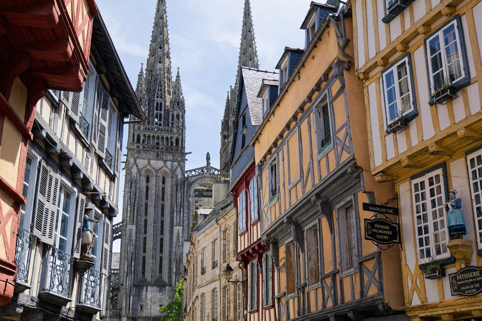 Flower-lined stone footbridges crossing the Odet river in Quimper's old town