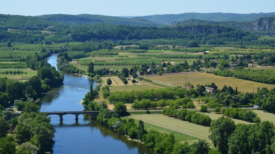 The view from Saint-Cyprien's hillside streets out over the Dordogne valley and surrounding walnut orchards at sunset