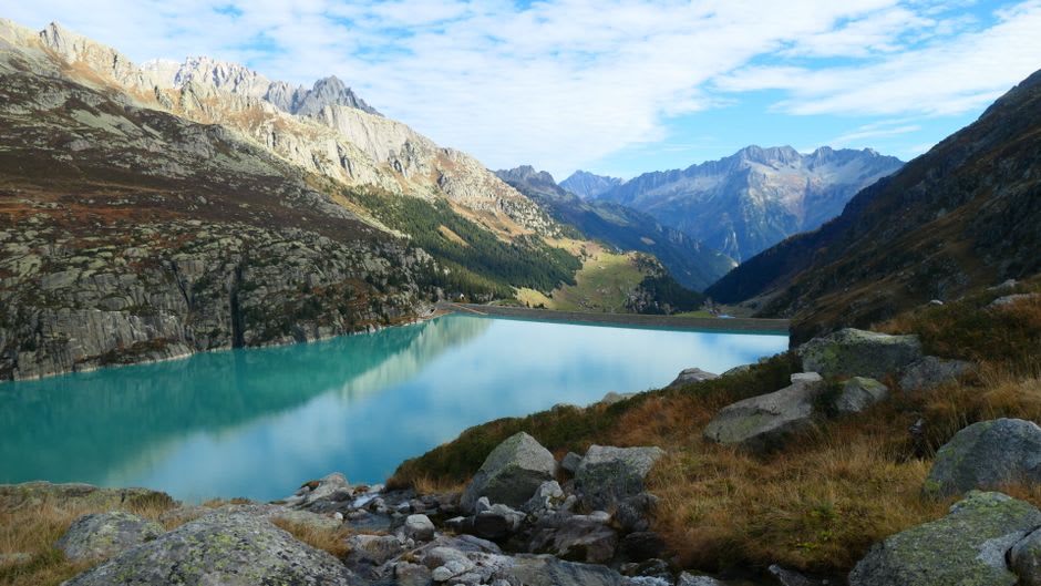 A turquoise glacial lake surrounded by bare granite peaks in the Néouvielle nature reserve above Saint-Lary