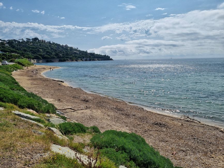 The wide sandy sweep of Pampelonne Beach near Saint-Tropez with beach umbrellas and clear turquoise water