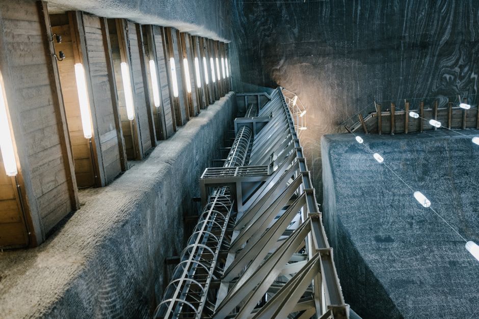 The dim underground salt galleries of Salins-les-Bains with wooden pumping mechanisms preserved along the tunnel
