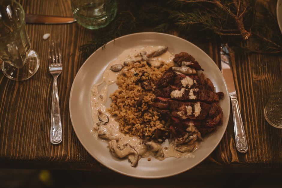 A rustic Burgundian meal of local charcuterie and mushrooms on a wooden table in a Saulieu auberge
