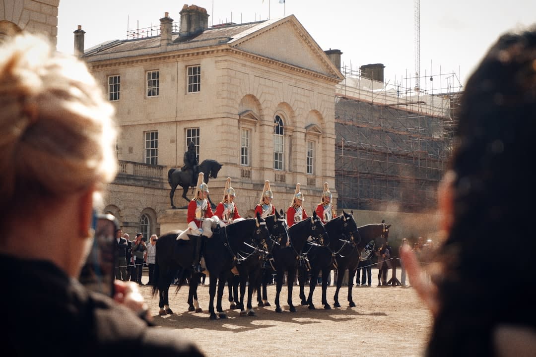 Cadre Noir riders in black uniforms performing classical dressage movements at Saumur's equestrian academy