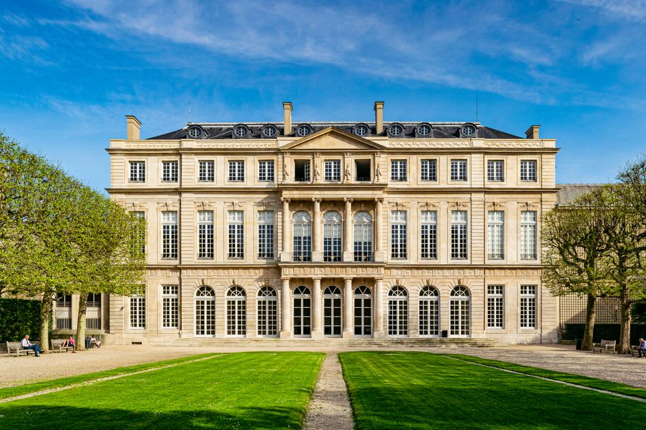 The long pink sandstone facade of the Château des Rohan seen from across the canal in Saverne