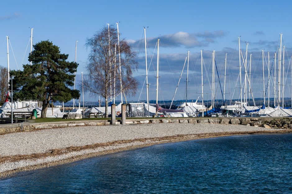 The Belle Époque harbour of Thonon-les-Bains on Lake Geneva with sailboats and the Swiss Alps visible across the water
