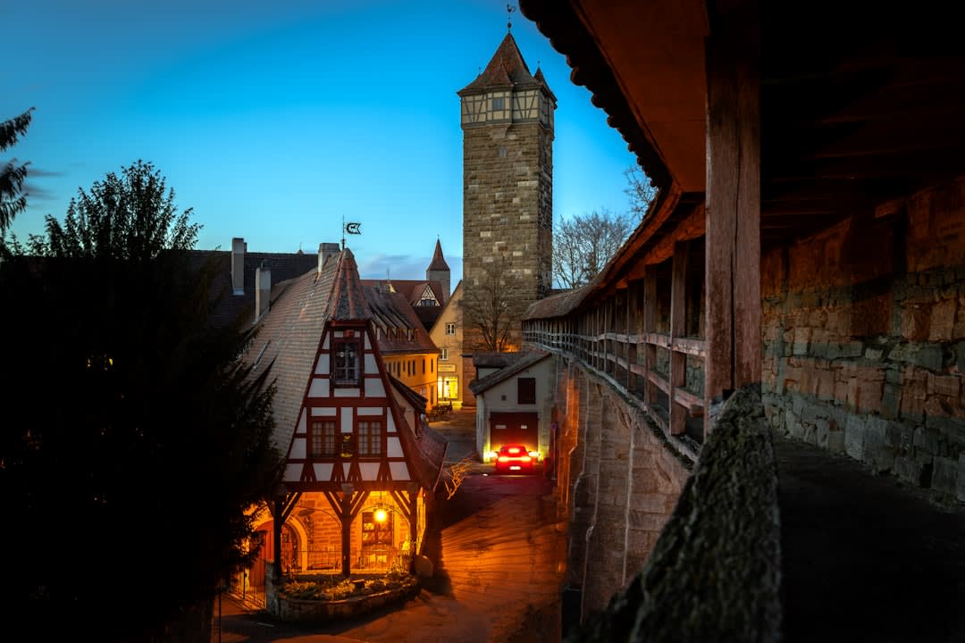 The half-timbered houses and busy cafe terraces of Place Plumereau in Tours at dusk