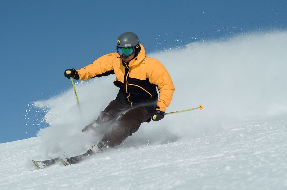 A skier carving down the steep, icy World Cup downhill piste of La Face above Val d'Isère
