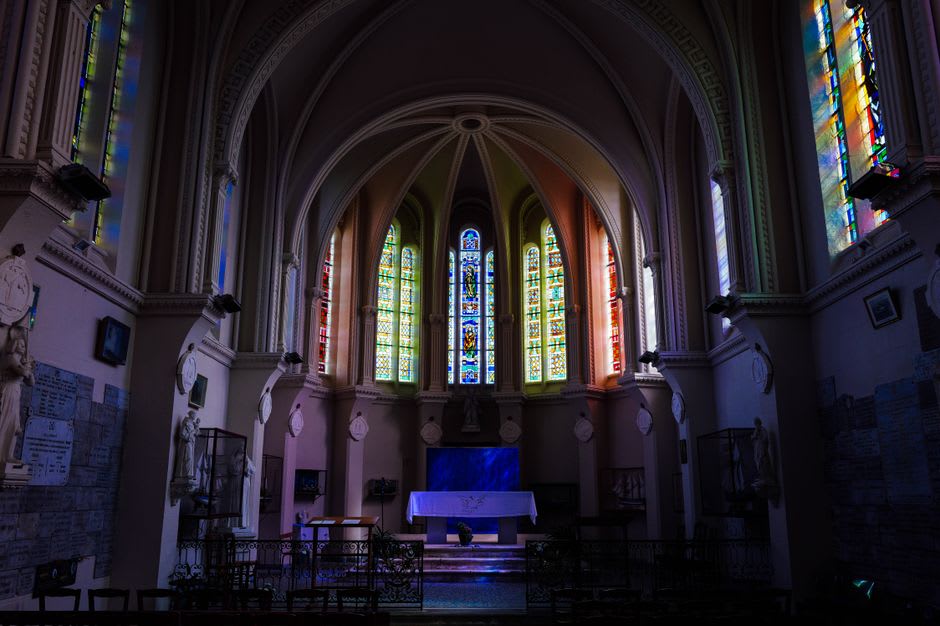 The stained-glass windows of Matisse's Chapelle du Rosaire flooding the white interior with colored light