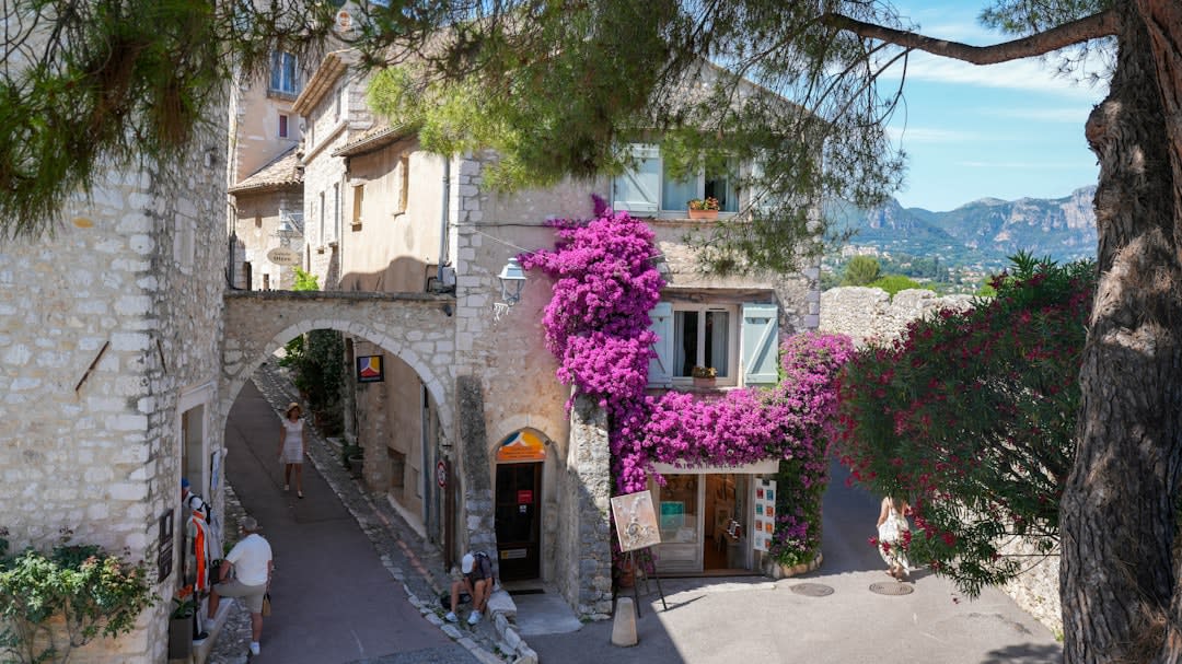 A narrow stone street with a fountain in Vence's medieval walled old town