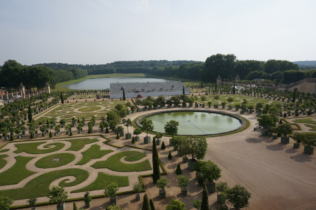 The thatched cottages and small lake of Marie-Antoinette's Hameau de la Reine in the Versailles gardens