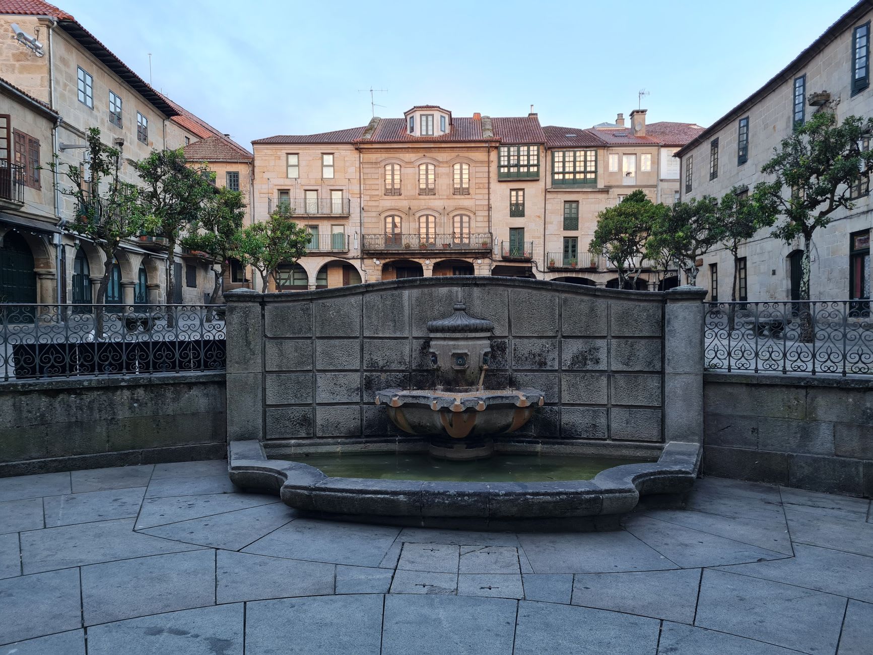 The ornate carved facade of Pontevedra's Basílica de Santa María la Mayor in morning light