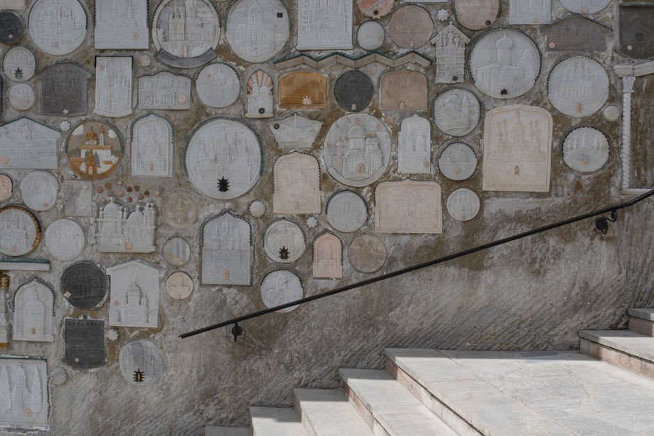 Weathered stone staircases cut directly into the rock face at Uplistsikhe