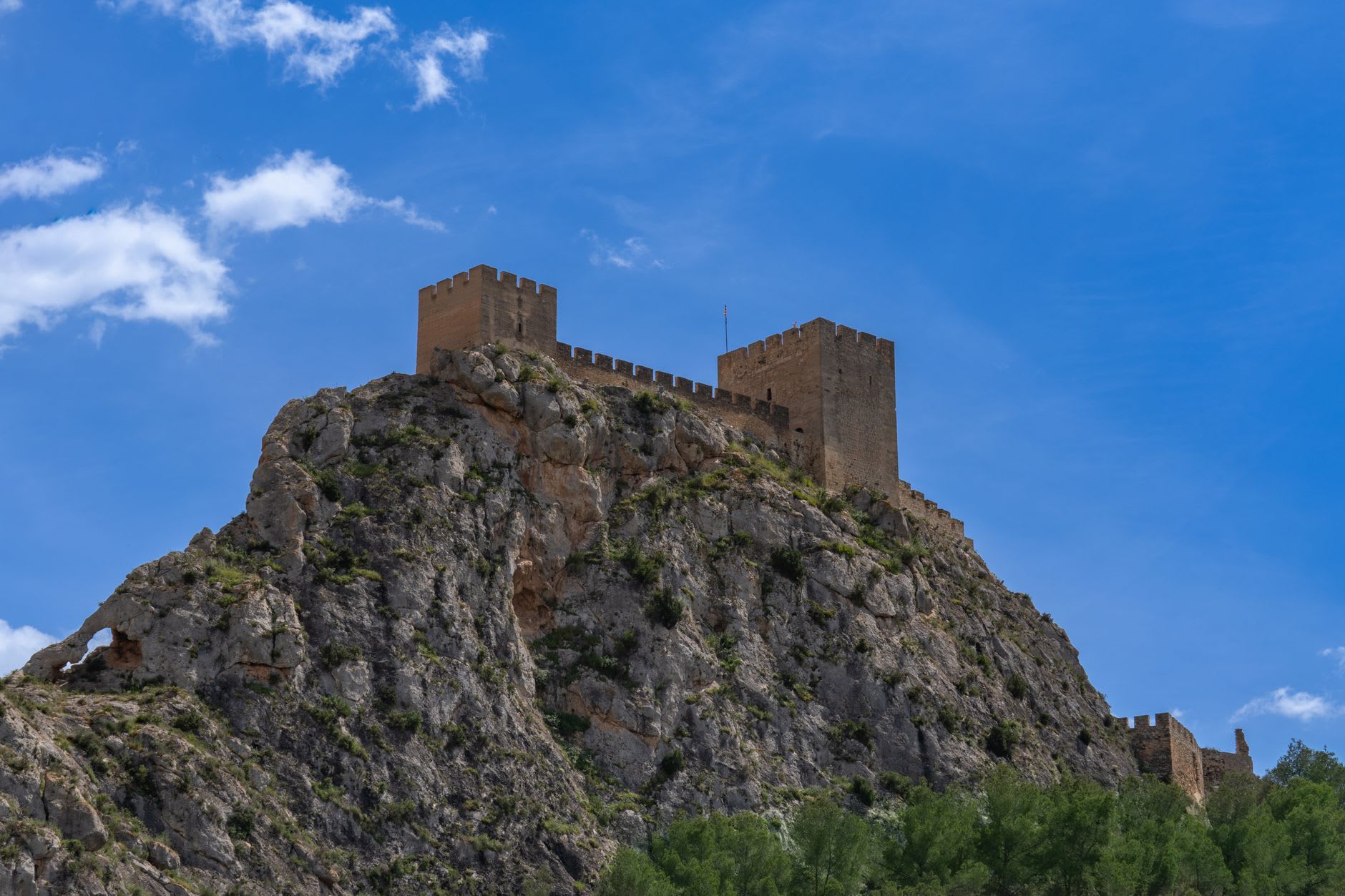The weathered stone walls of the Moorish Castle's Tower of Homage seen up close, ancient masonry textured by centuries of Mediterranean weather