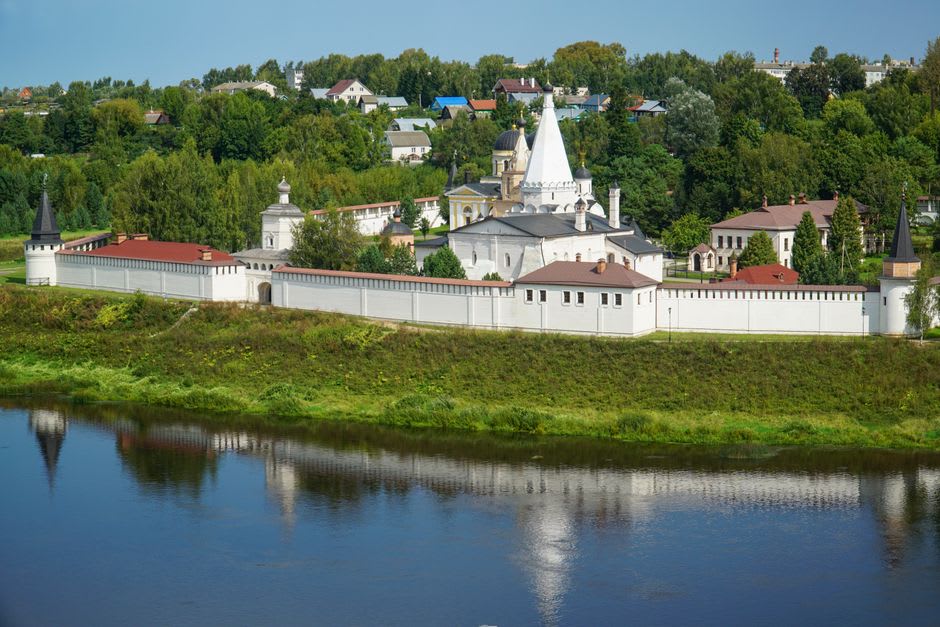 Znamensky Monastery seen across a green meadow on the far bank of the Klyazma River