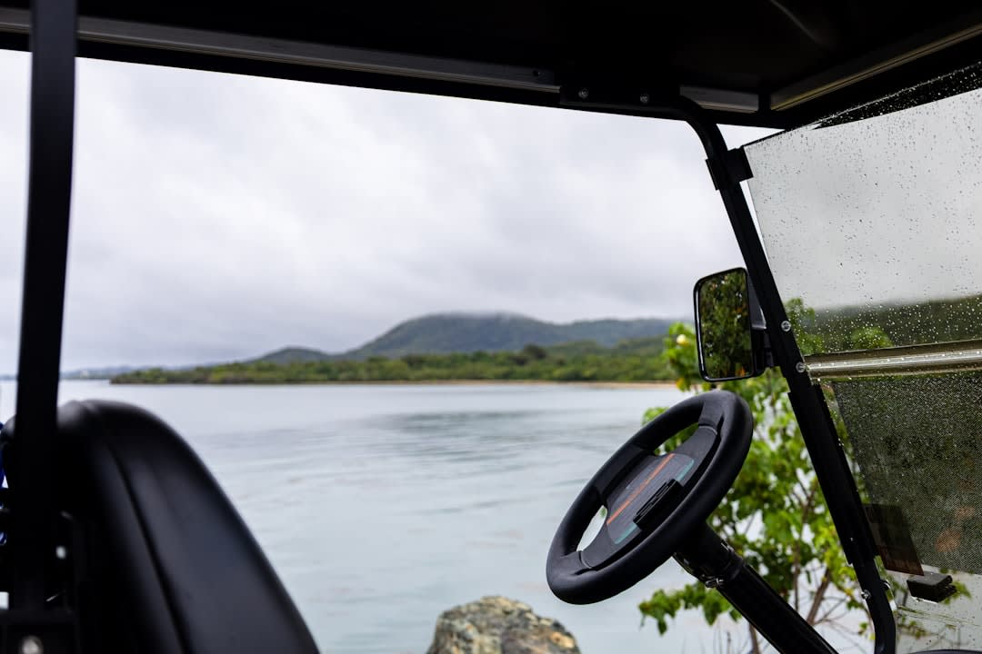 Green Island's coral sand beach fringed by dense tropical rainforest at the water's edge