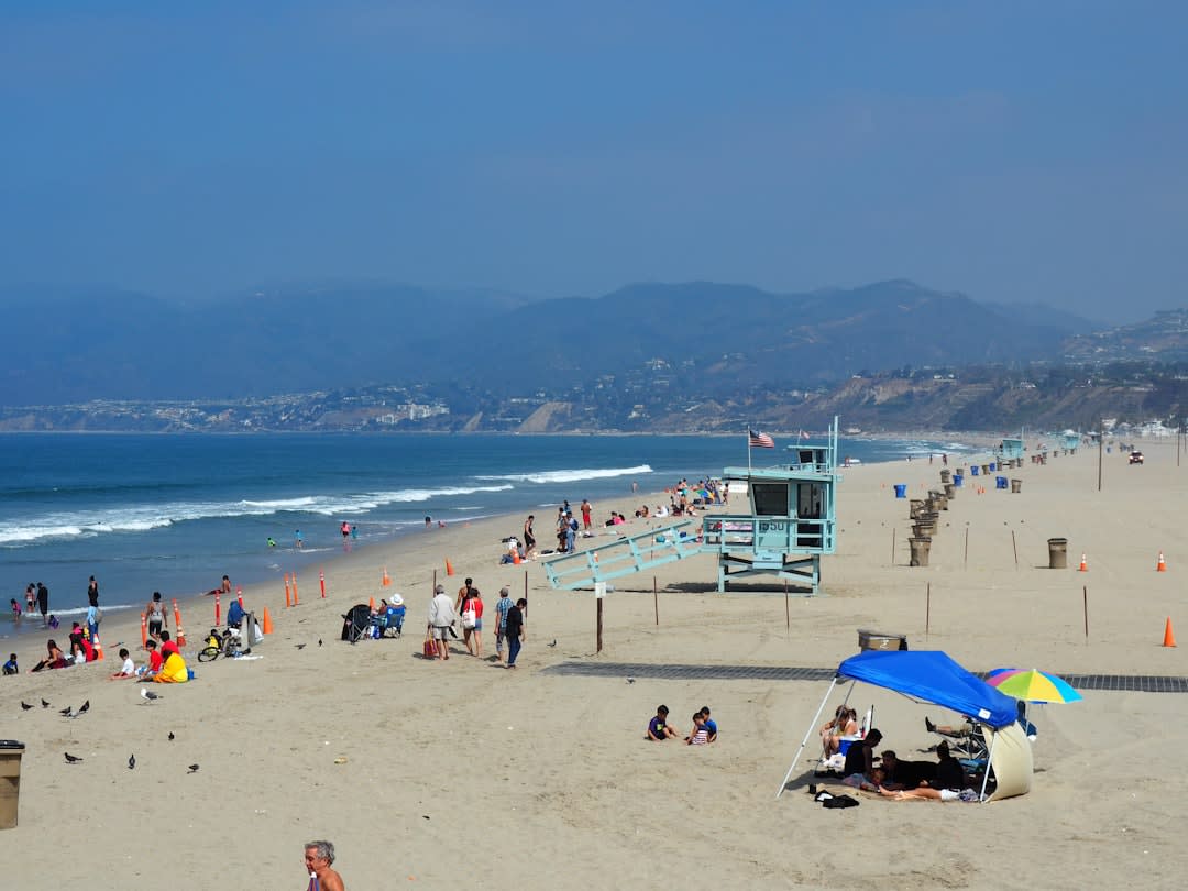 Mission Beach's long stretch of golden sand with rainforest-covered hills rising directly behind it