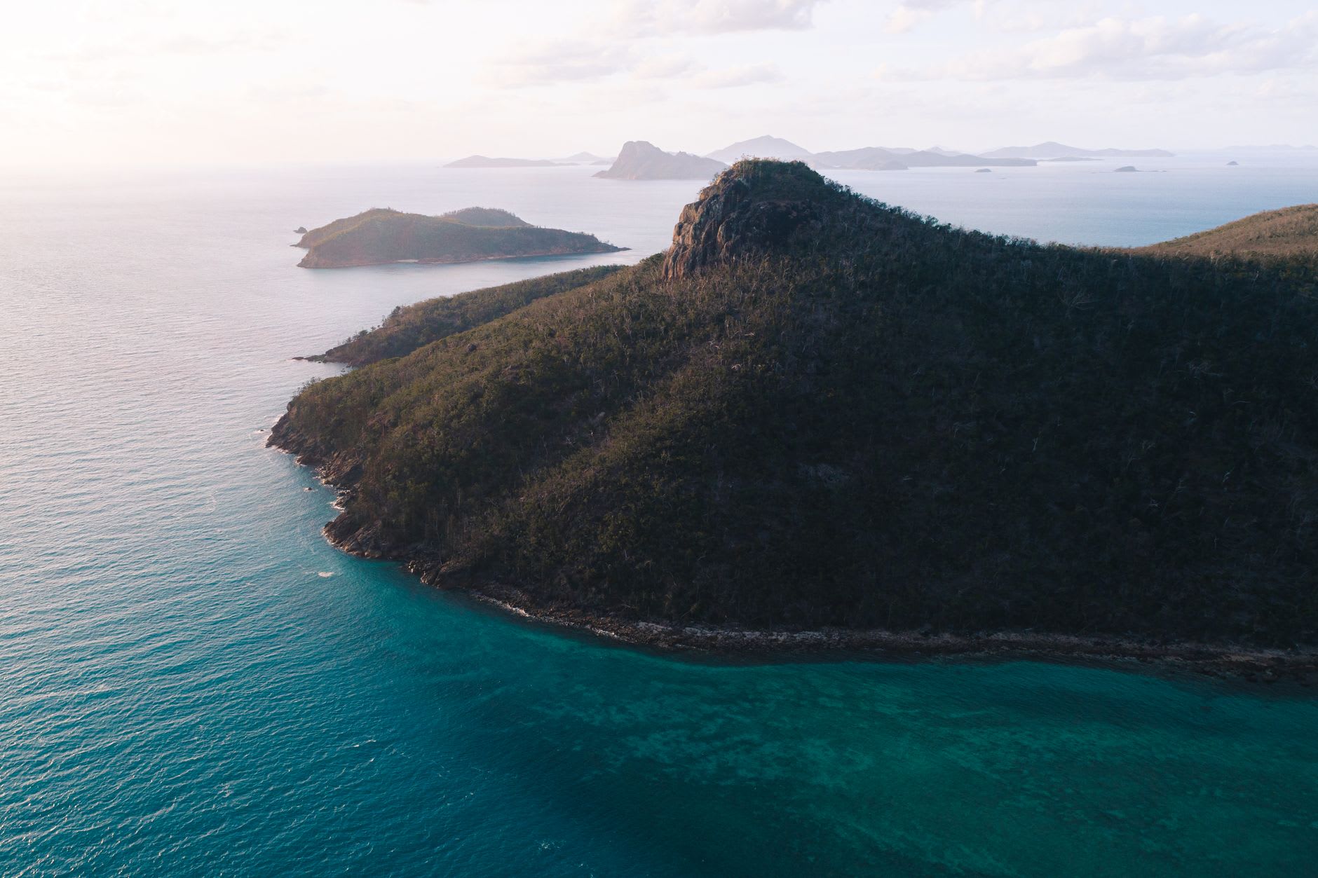 Snorkelers at the fringing reef of Hook Island in the Whitsundays — coral and tropical fish in clear turquoise water