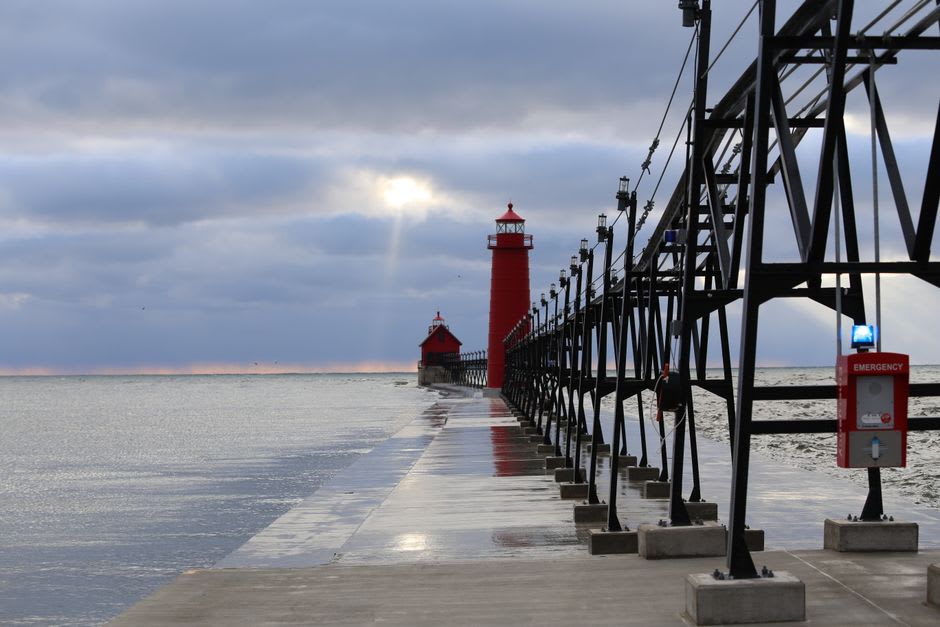 Morning walkers and cyclists on Grand Haven's waterfront boardwalk along the Grand River
