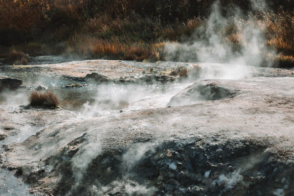 Steam rising from a hot spring feeding into the edge of Lake Magadi