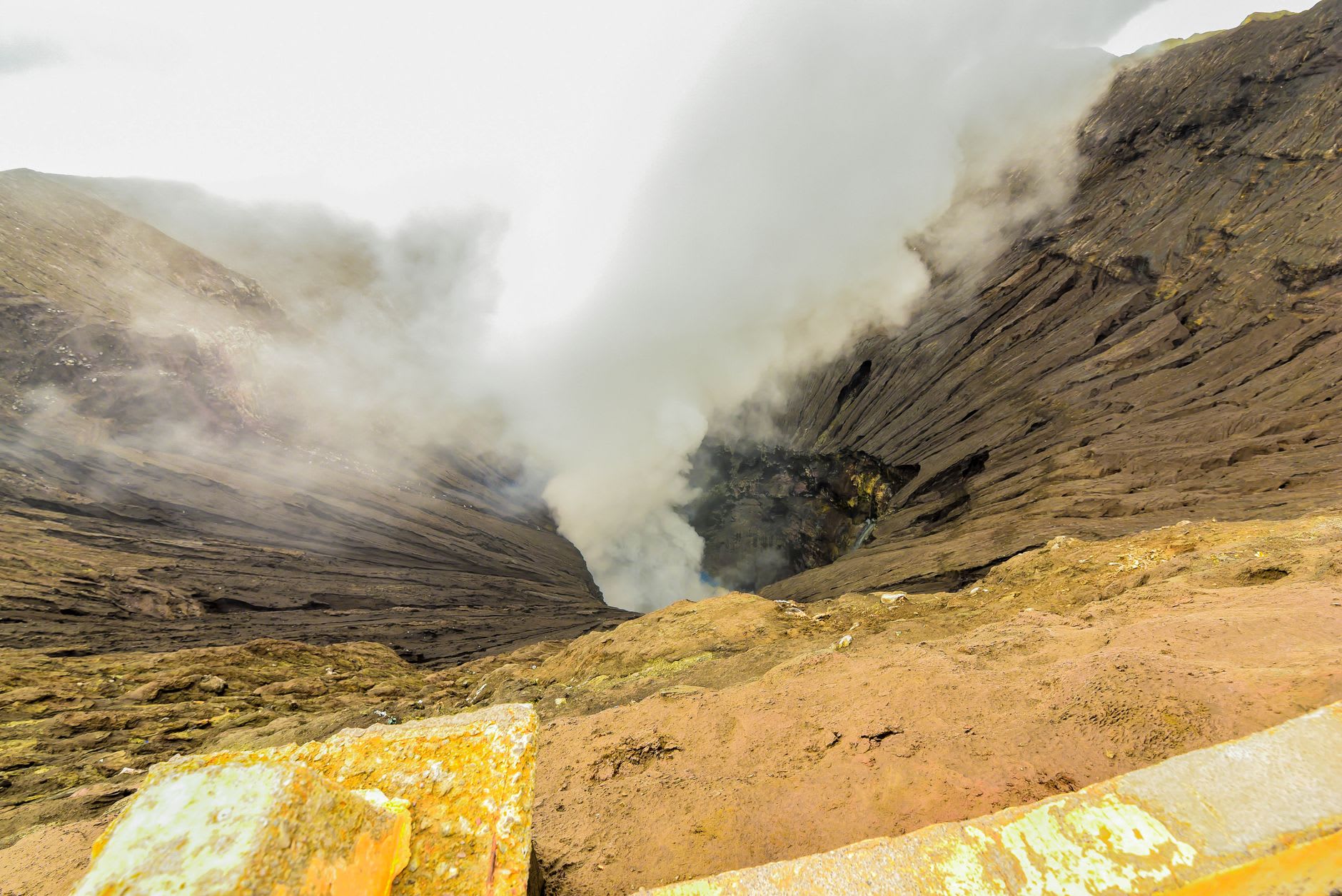 Steam rising from fumarole vents on the interior walls of Menengai Crater on a cool morning