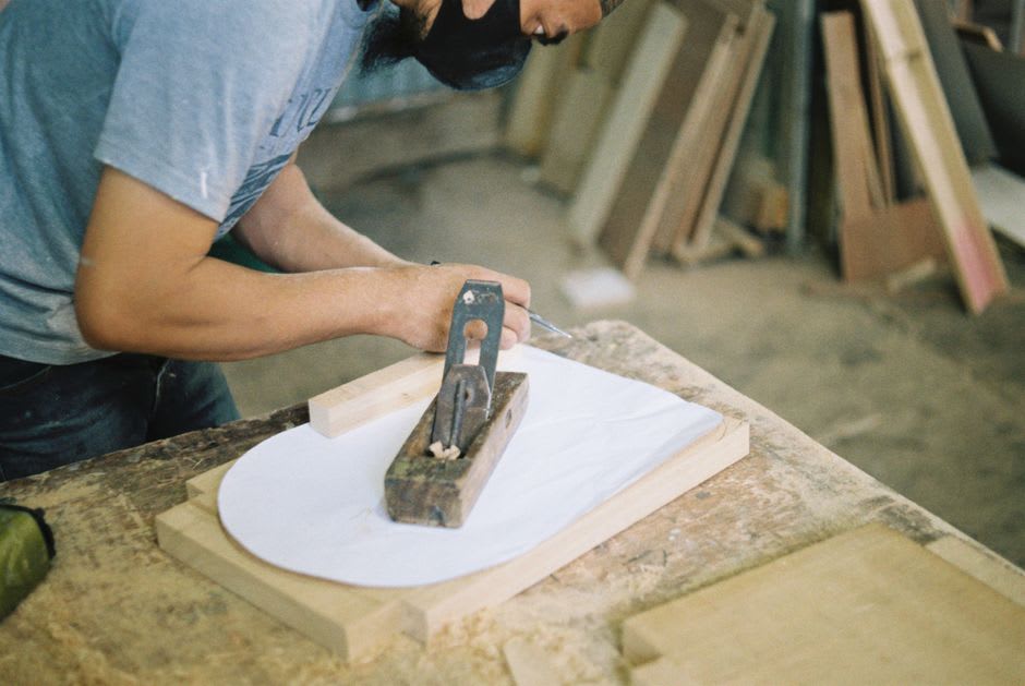 Wood carving tools and mahogany furniture pieces inside the Maison du Bois workshop