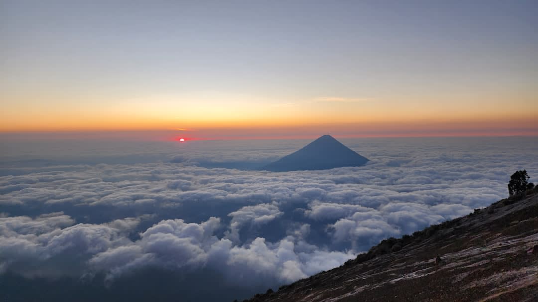 Hikers bundled against the cold at Acatenango's summit at sunrise