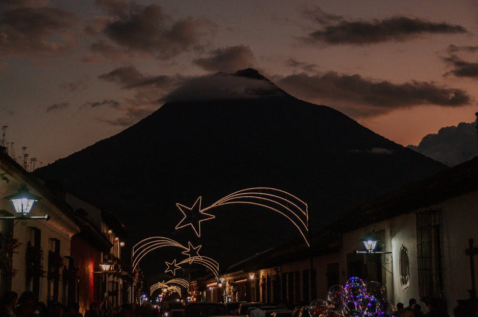 Colonial street in Antigua Guatemala with the Santa Catalina arch and Agua volcano in the background