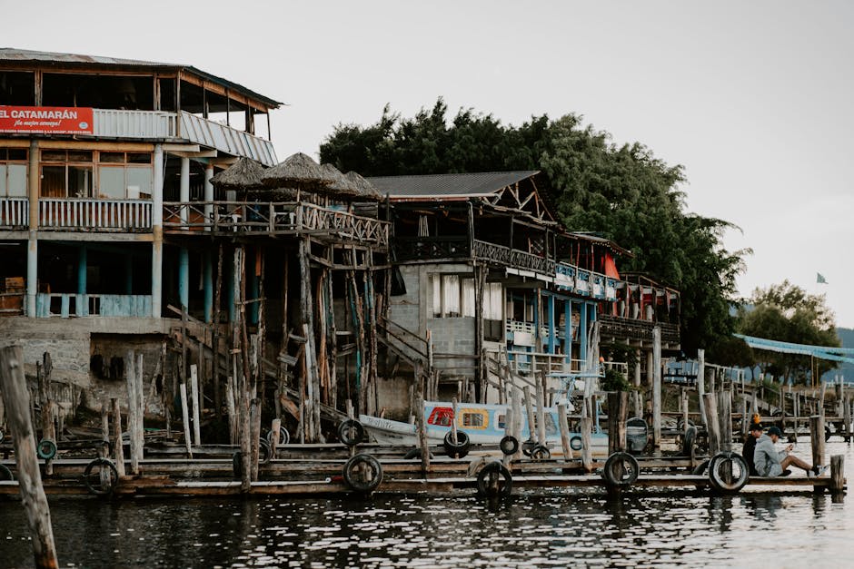 Tropical lakeside town at dusk with warm golden light on the water