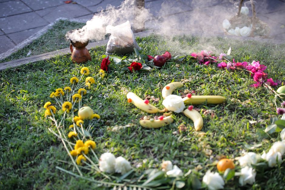 Marigold petals and burned offerings from a recent Maya ceremony at one of Iximché's stone altars