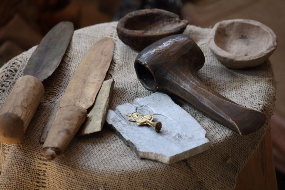 Small on-site museum display of obsidian tools and jade artifacts from Kaminaljuyú