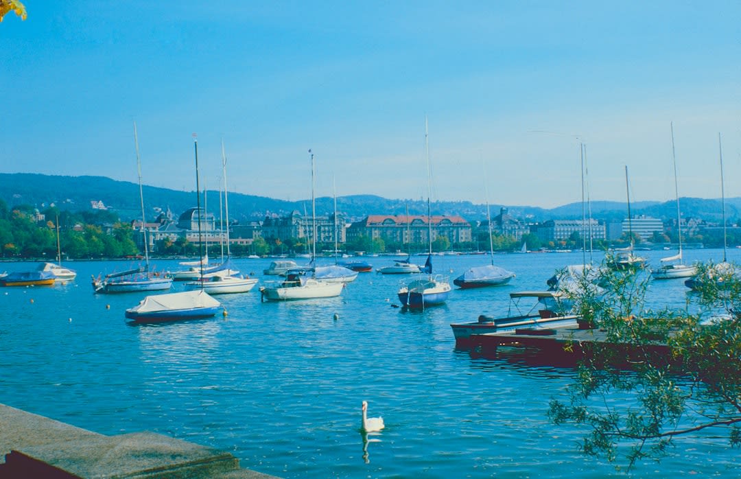 Lakeside promenade at Lago de Amatitlán with fishing boats and Volcán de Pacaya behind