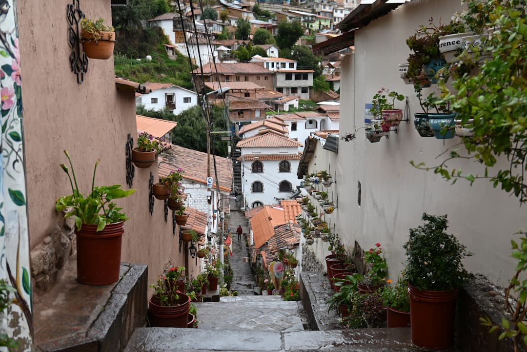 Whitewashed colonial houses on a steep hillside street in Mixco overlooking Guatemala City