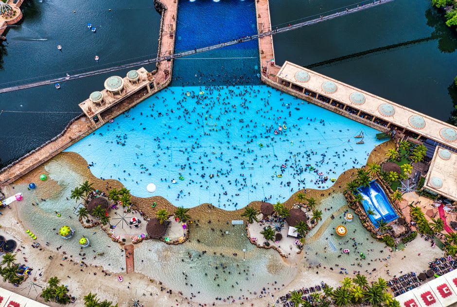 Families enjoying the wave pool and water slides at the Xocomil water park near Retalhuleu