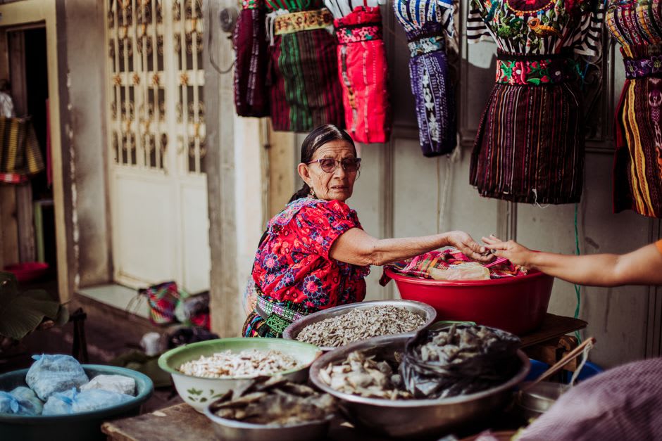 Sololá market day with vendors in traditional K'iche' Maya dress selling produce and textiles