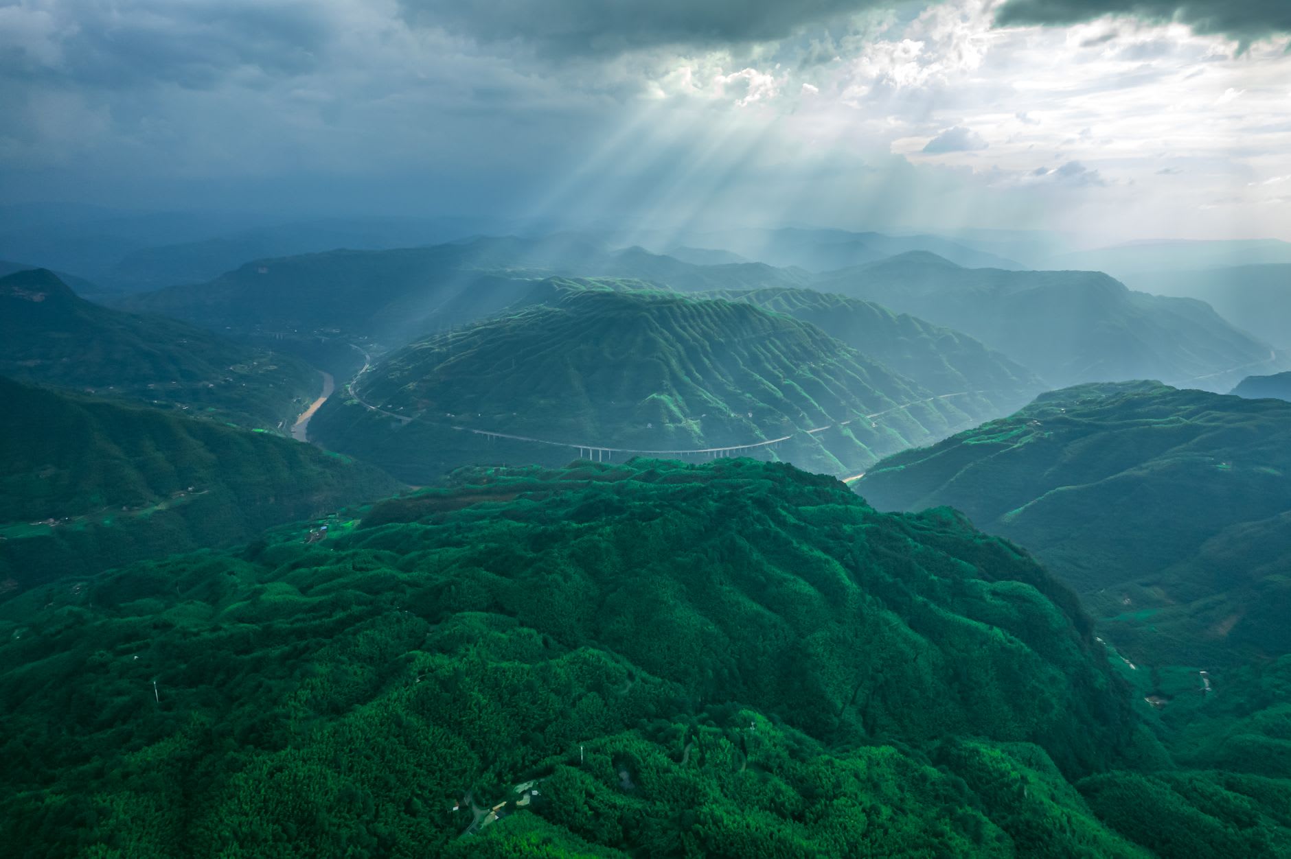 The twin summit temples of Fanjingshan perched on a split rock pillar, joined by a small stone bridge, clouds streaming past