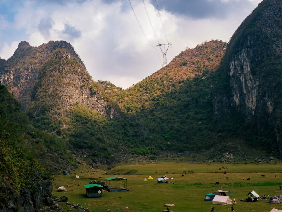 Karst limestone cliffs and cave entrance along the Getu River in Ziyun County
