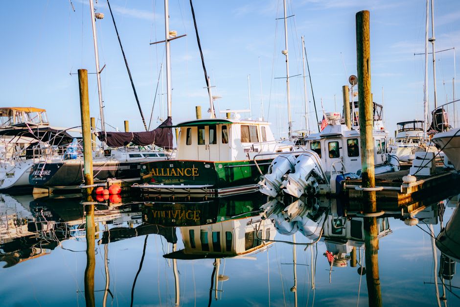 Sport fishing boats docked at a marina on Grand Isle at sunrise