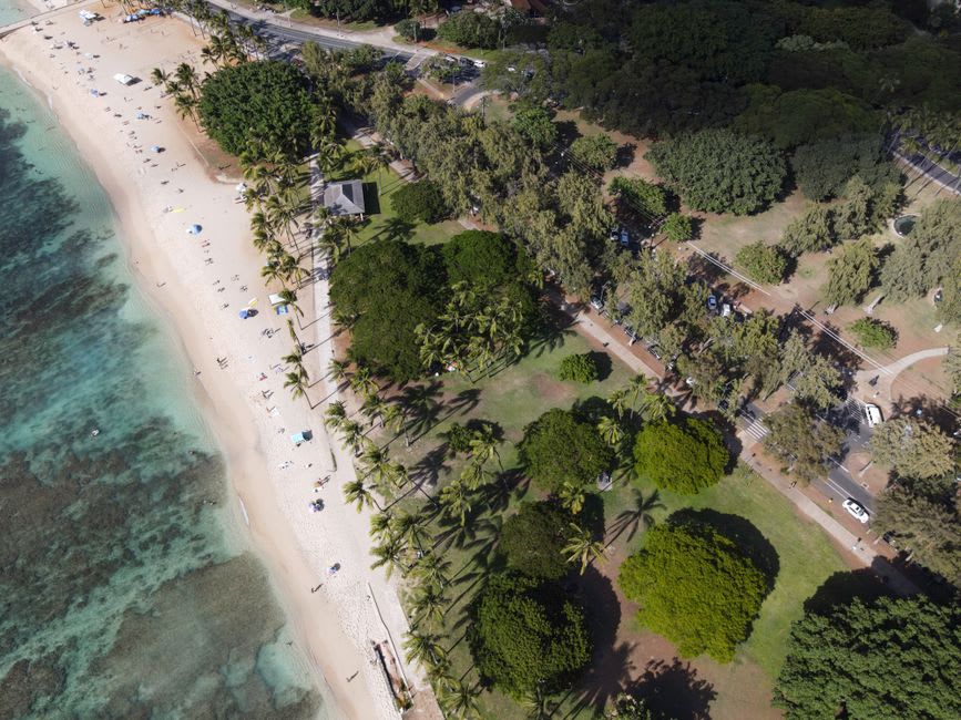 Families snorkeling and swimming inside the rock-walled protected lagoon at Lydgate Beach Park