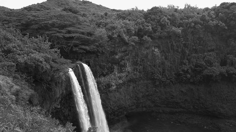 Vista hacia la poza de la base de Wailua Falls desde parte del camino del sendero no oficial