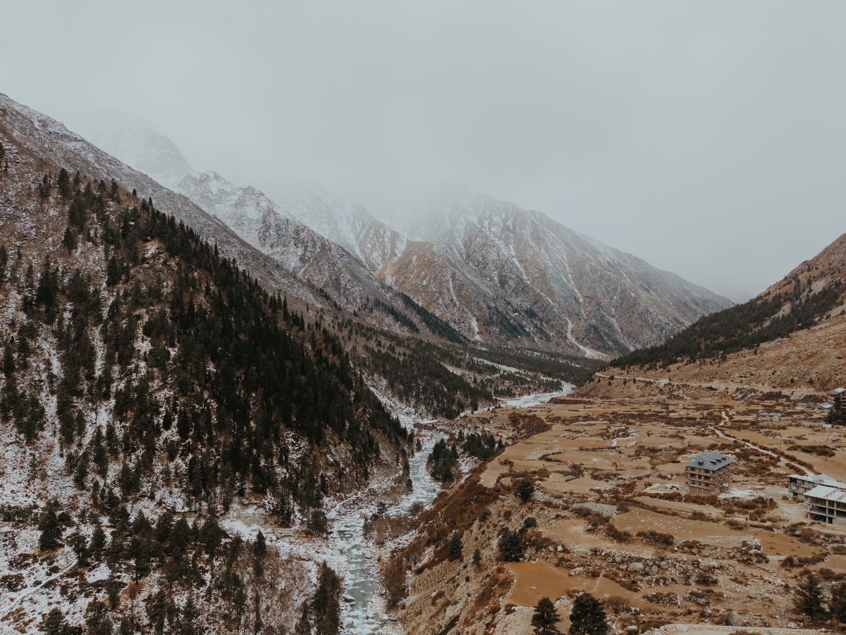 The last village of Chitkul at the Tibet border with its wooden houses, small temple and the glaciated peaks of the Baspa Valley rising directly behind