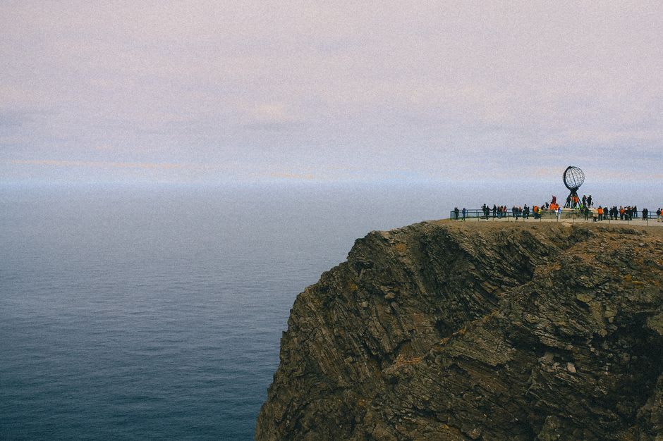 The windswept grassy point of Cape Soya with the northernmost point monument and the sea stretching toward the horizon on a clear day