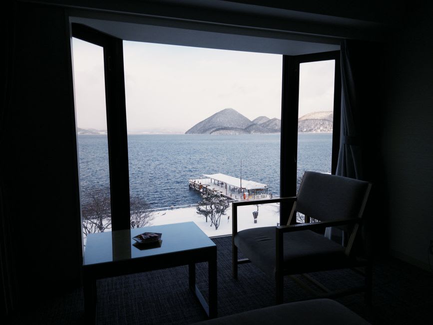Lake Toya seen from the Usu ropeway station, the round caldera lake with its central islands and Mount Yotei in the distance