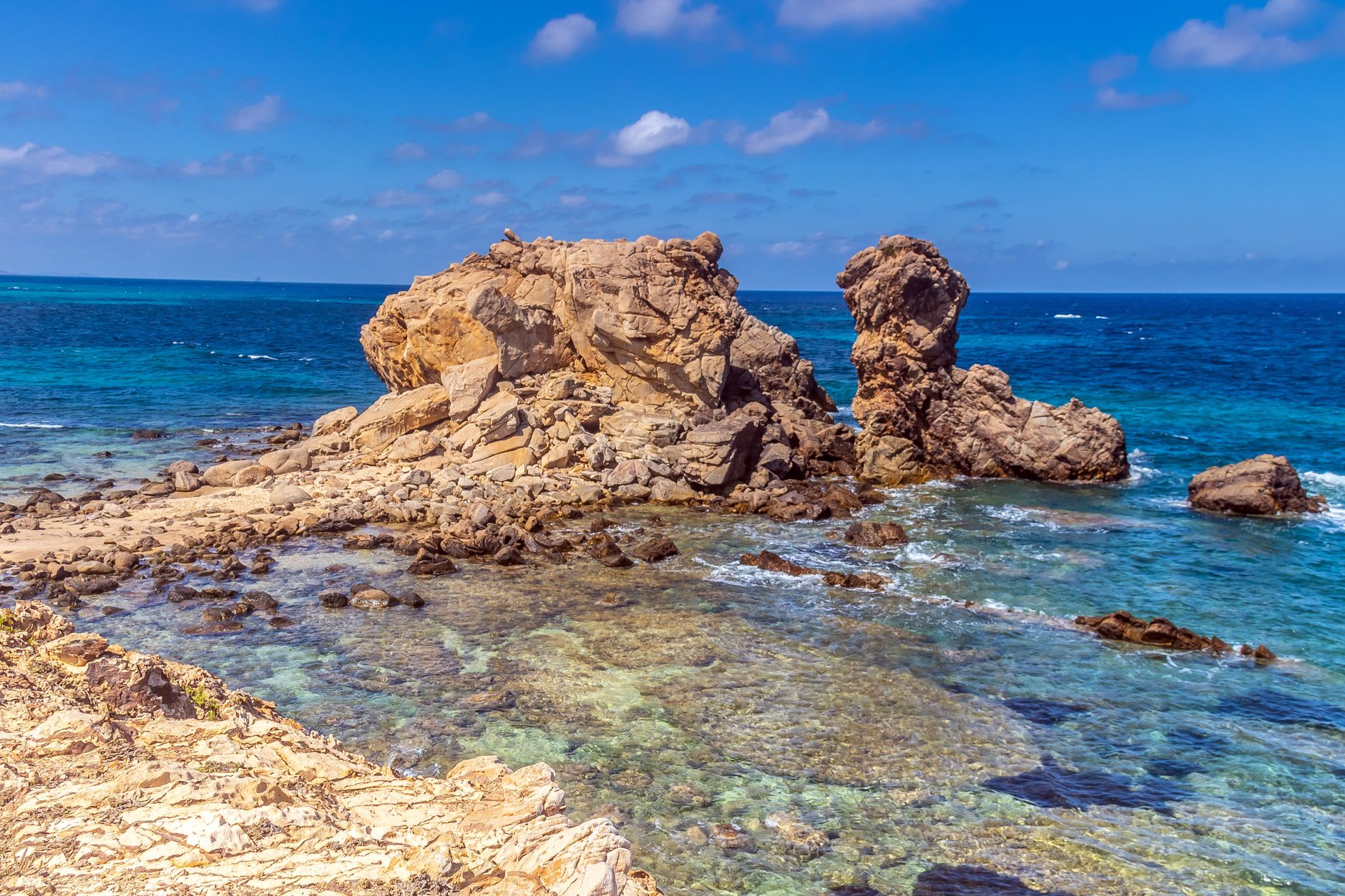 The white sand beach of Detwah Lagoon on Socotra's west coast, turquoise water utterly still in the morning calm before the monsoon wind picks up