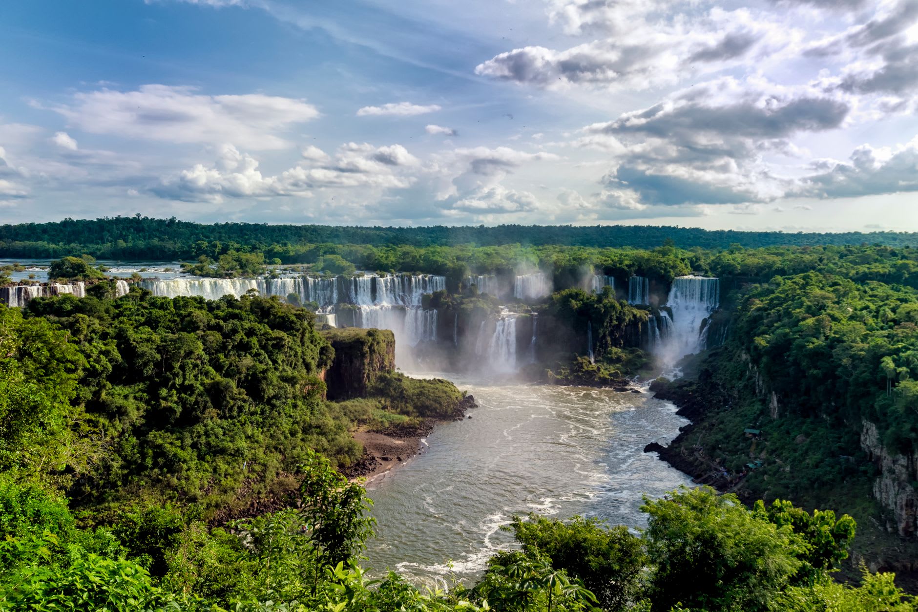 Zodiac boat approaching the curtain of the Salto San Martín waterfall with passengers about to get completely soaked