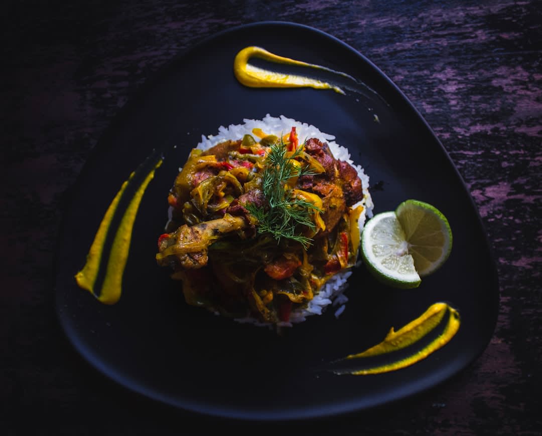 A fiery Chettinad chicken curry served on a banana leaf with rice and roasted spices visible in the gravy
