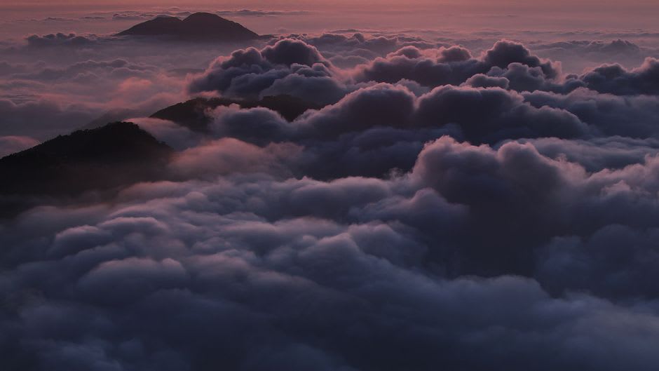 Mist pooling in the valleys below Mullayanagiri peak at sunrise, Western Ghats, Karnataka