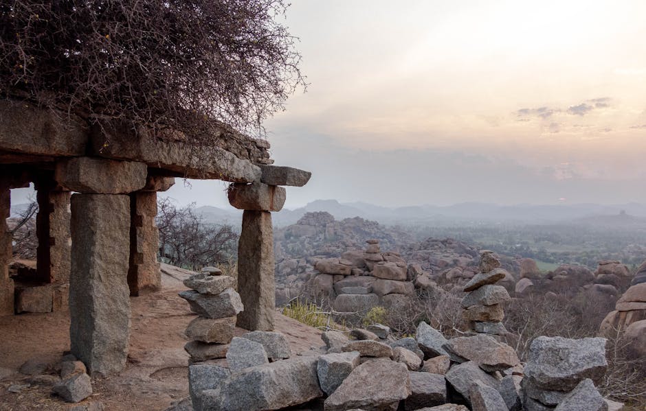 Sunset over the boulder-strewn landscape and temple ruins of Hampi